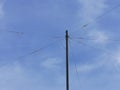 Pole with electrical wires against a blue sky Royalty Free Stock Photo