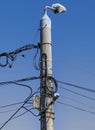A pole full of cables under the blue sky Royalty Free Stock Photo