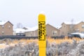 Pole marker with warning sign for natural gas pipeline buried underground