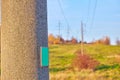 A pole with a sign on a high-voltage power line Royalty Free Stock Photo