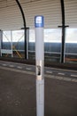Pole and sign of the smoking zone on a platform where smoking is allowed 3 meters around the pole in the netherlands.