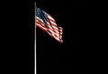 Pole with waving Old Glory American flag isolated on black, copy space Royalty Free Stock Photo