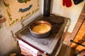 Polenta cooked in a copper cauldron on a wood stove