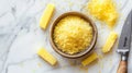 Polenta and cornmeal in wooden bowl with sliced cornmeal cakes on marble background Royalty Free Stock Photo