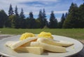 Polenta with cow cheese in a plate served in a beautiful mountains landscape.