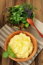 Polenta with green basil in wooden bowl with assorted salad bowl