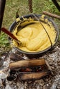 Polenta making in a cast-iron pan in the traditional village of Archita, Transylvania, Romania