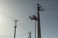 Poles with electrical wires. Silhouettes of communication racks. High voltage lines. Energy transfer