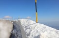 poles painted yellow and black driven into the snow to mark the edge of the icy mountain road Royalty Free Stock Photo