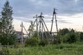 Poles with power lines at sunset in the village of Parabel, Russia
