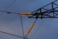 Poles at a power plant at sunset as a background Royalty Free Stock Photo