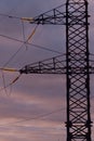 Poles at a power plant at sunset as a background Royalty Free Stock Photo