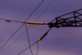 Poles at a power plant at sunset as a background Royalty Free Stock Photo