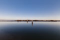 Lagoon of Marano Lagunare with bricole, canal for boats and island in the sea. Royalty Free Stock Photo