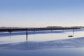 Poles on the sea, canal for boats, above the lagoon of Marano Lagunare, Udine, Italy.