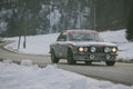 POLHOV GRADEC, SLOVENIA, 10.2.2023: Vintage Ford Escort is driving on snowy public road as part of a winter oldtimer rally
