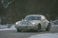 POLHOV GRADEC, SLOVENIA, 10.2.2023: Vintage Porsche 911 is driving on snowy public road as part of a winter oldtimer rally
