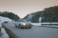 POLHOV GRADEC, SLOVENIA, 10.2.2023: Vintage Porsche 911 is driving on snowy public road as part of a winter oldtimer rally