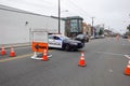 A police blocking traffic is seen near a road closed sign at a highway construction site