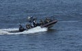 Police boat floating on water, armed soldiers of Special Forces aboard