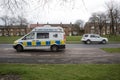 Police Camera Enforcement Unit Van parked at side of the road to enforce speed restrictions. Speed camera sign visable as blurred