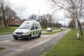 Police Camera Enforcement Unit Van parked at side of the road to enforce speed restrictions. Silver cars heading towards van