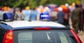 Police car with blue sirens during the riot