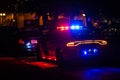 Police car with emergency lights flashing at night in city Royalty Free Stock Photo