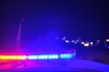 Police car flashing lights in the night blurred selective focus Royalty Free Stock Photo