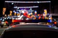 Police car lights at night in city with selective focus and bokeh Royalty Free Stock Photo