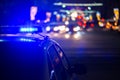 Police car lights at night in city with selective focus and bokeh Royalty Free Stock Photo