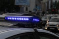 Police car with lights turned on. City lights on the background. With vintage and blur effect. Royalty Free Stock Photo