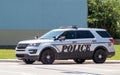 Police car parks on a street watching local traffic Royalty Free Stock Photo