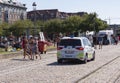 Police car with police officers watching people in a recreational area