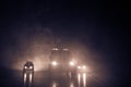 Police car chasing a car at night with fog background. 911 Emergency response police car speeding to scene of crime. Selective foc Royalty Free Stock Photo