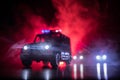 Police car chasing a car at night with fog background. 911 Emergency response police car speeding to scene of crime. Selective foc Royalty Free Stock Photo