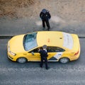 The police check the driver and passenger of a taxi for a pass and admission order in Moscow when isolated from the coronavirus