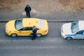 The police check passenger of a taxi for a pass and admission mode in Moscow when quarantine from the coronavirus epidemic - May