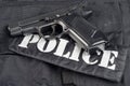 Police concept handgun on black uniform background Royalty Free Stock Photo