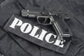 Police concept - handgun on black uniform Royalty Free Stock Photo