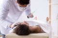 The police coroner examining dead body corpse in morgue