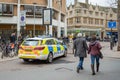 Police emergency response vehicle seen parked near a busy Saturday shopping area in the town centre.