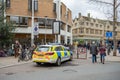 Police emergency response vehicle seen parked near a busy Saturday shopping area in the town centre.