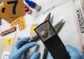 Police expert analyzes with magnifying glass some old grapple of the crime scene