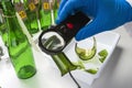 Police expert gets blood sample from glass bottle in Criminalistic Lab