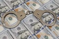 Police handcuffs against a hundred dollar bills USA. Concept violation of the law, corruption, financial fraud. Royalty Free Stock Photo