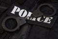 Police handcuffs on black uniform Royalty Free Stock Photo