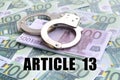 Police handcuffs on euro bills and article 13 inscription Royalty Free Stock Photo