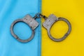 Police handcuffs lie on the Ukrainian flag. Concept: Ukrainian justice, trial of criminals. Royalty Free Stock Photo