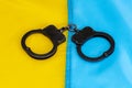 Police handcuffs lie on the Ukrainian flag. Concept: Ukrainian justice, trial of criminals. Royalty Free Stock Photo